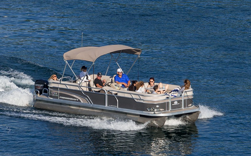 Pontoon boat on the water with a group enjoying a Lake Lewisville ride